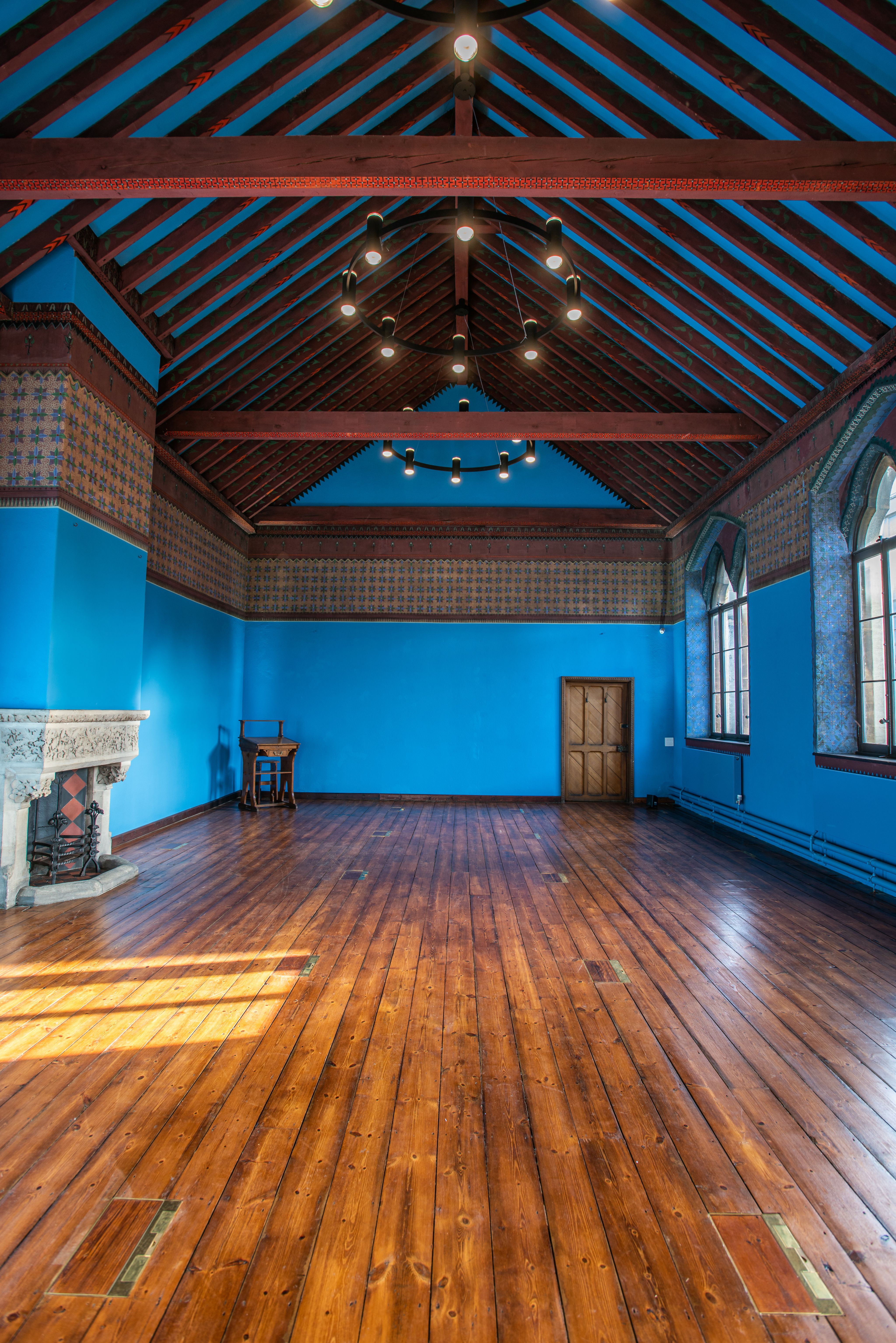 Interior of Westwood Room showing bright blue walls and painted decoration