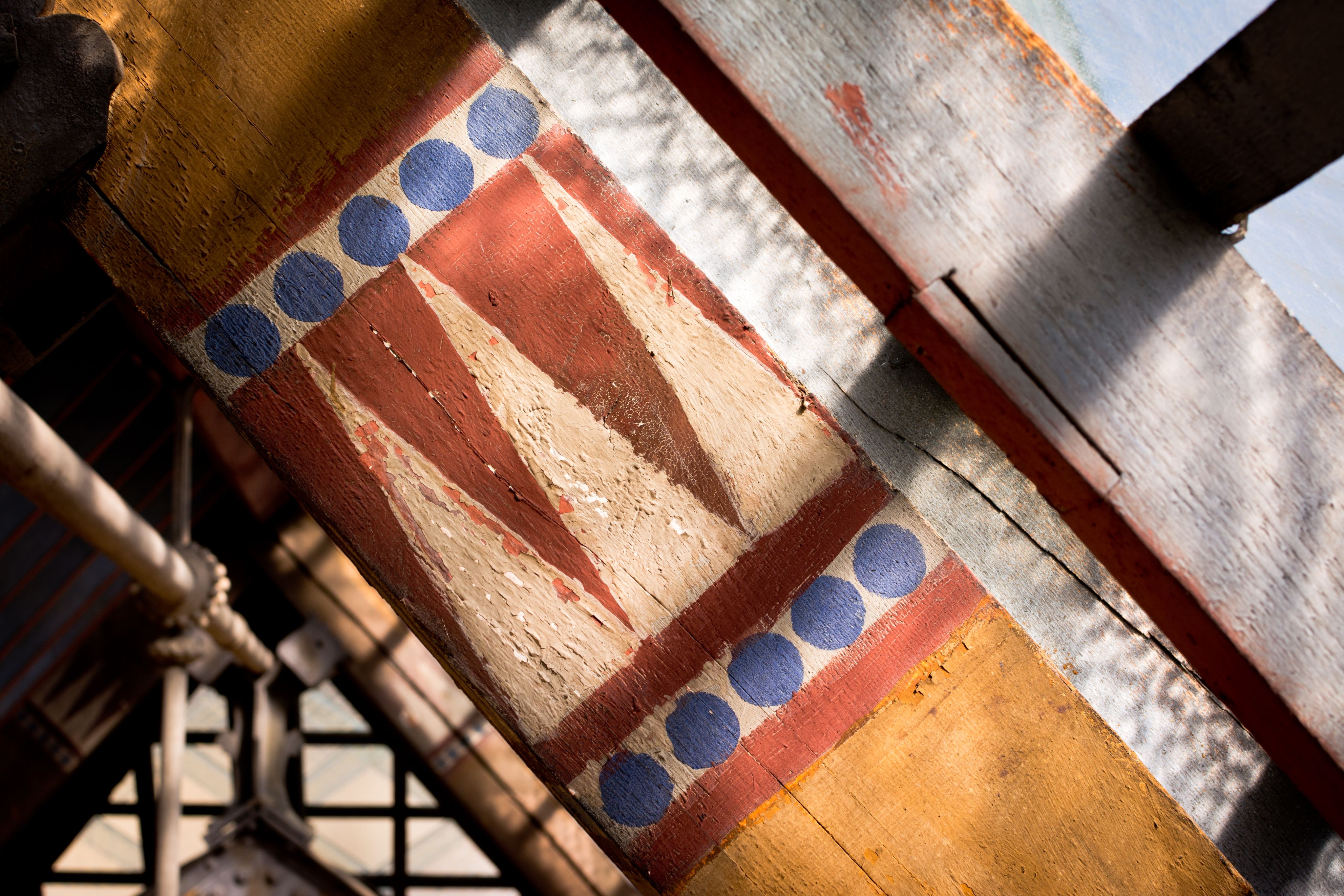 Detail of painted decoration on wooden roof beams
