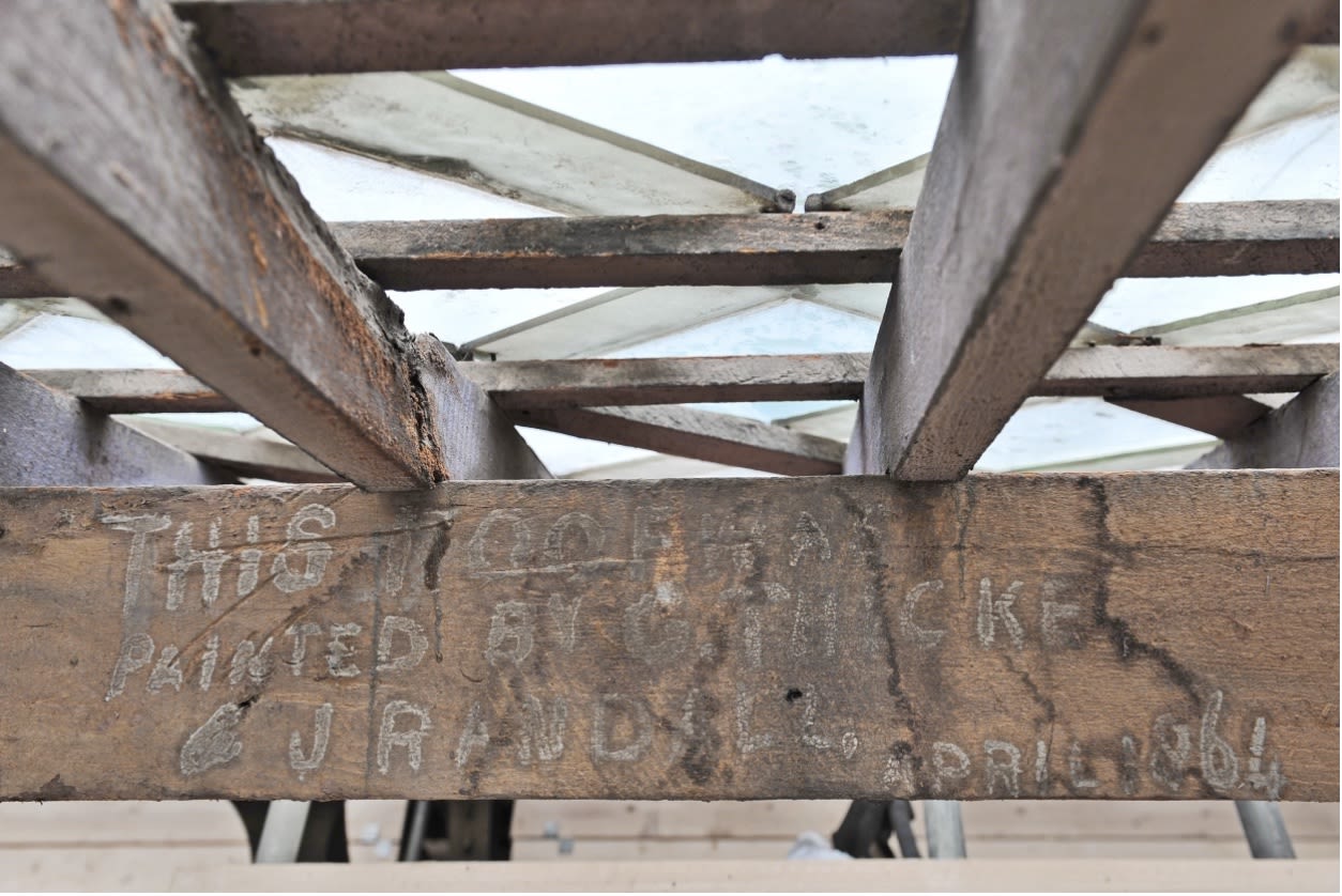 Roof beam with decorators' names painted on it